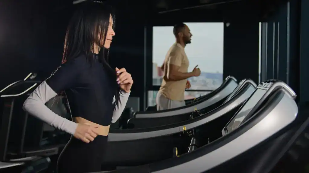 Person walking on a treadmill with incline to burn more calories and lose belly fat