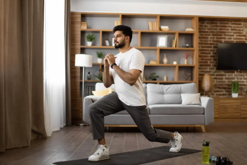 Men doing forward lunges at home for leg strength