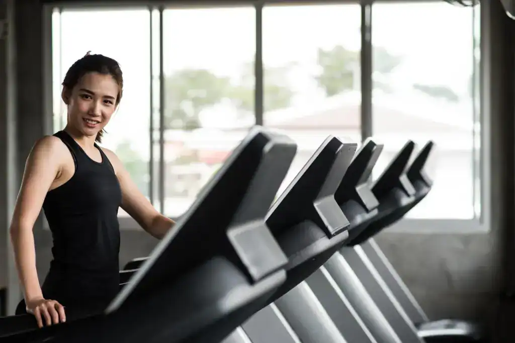 Woman performing steady-state treadmill walking to burn belly fat at home