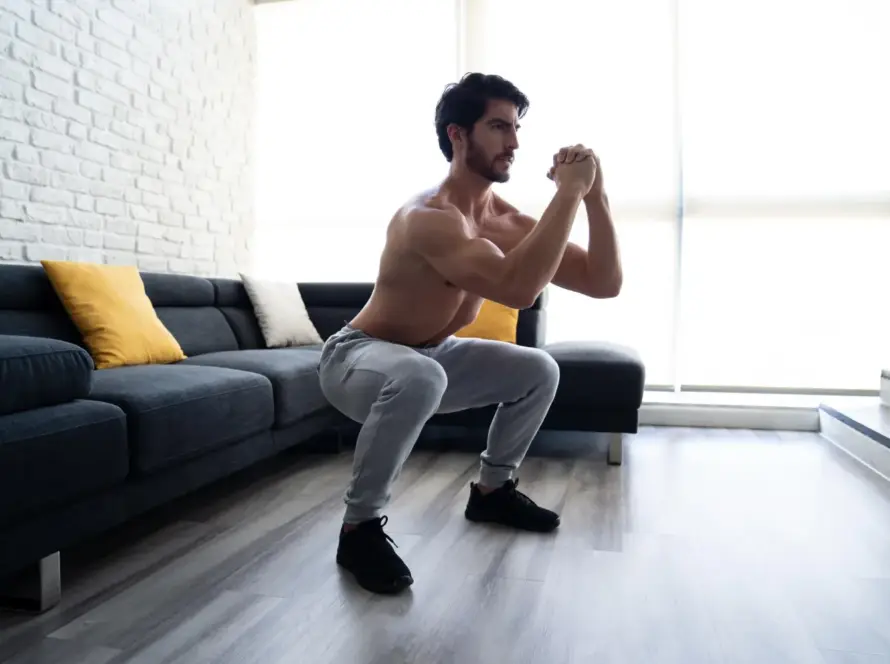 A person performing leg exercises at home without using equipment