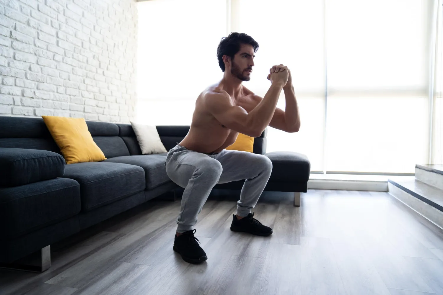 A person performing leg exercises at home without using equipment