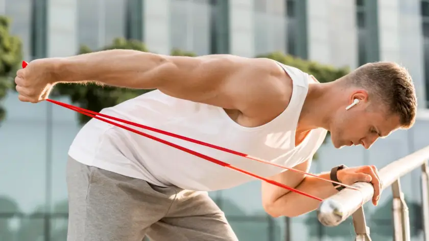 Beginner doing triceps kickback exercise with resistance band