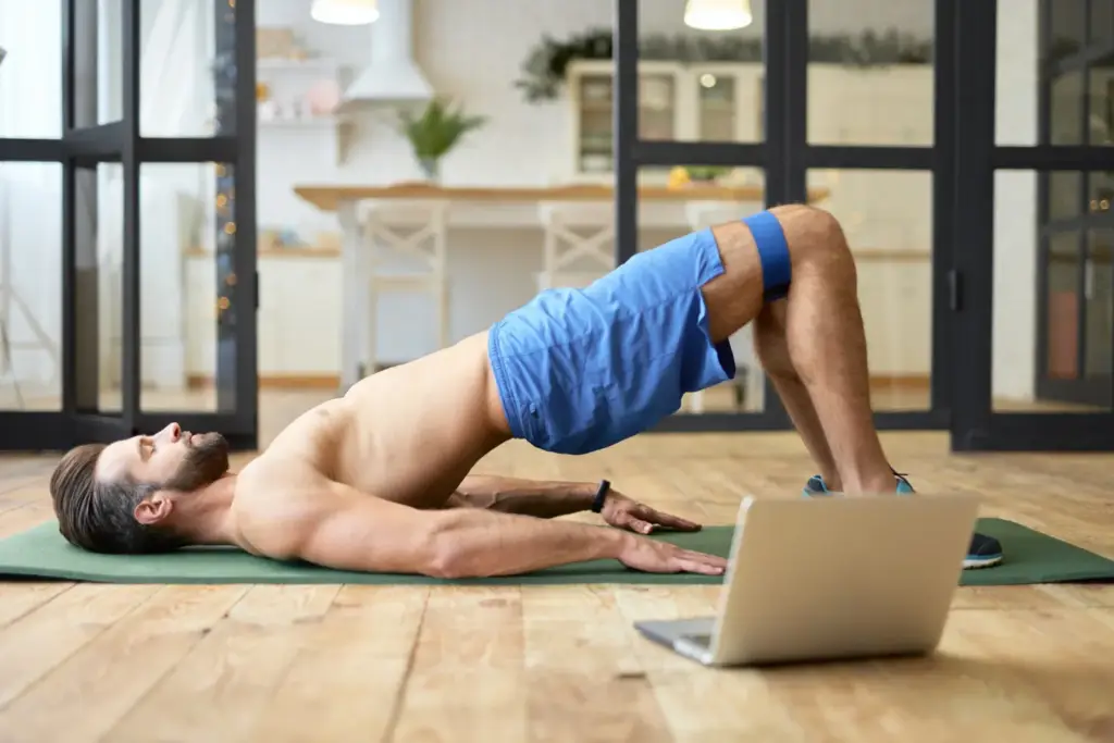 Person doing glute bridges at home on a yoga mat