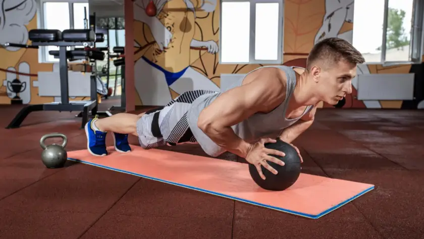 Beginner doing diamond push-ups on the floor for arm strength