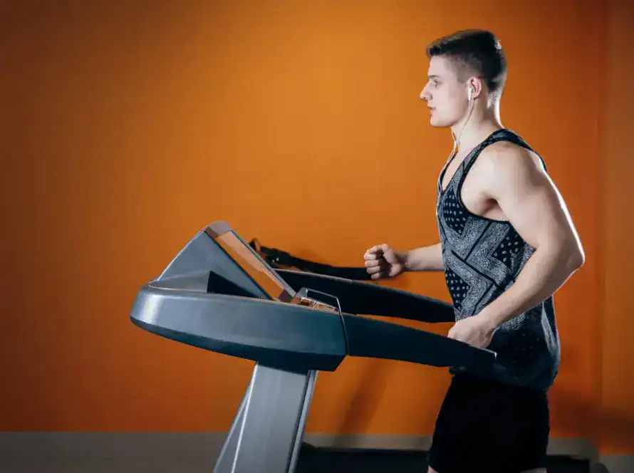 Person exercising on a treadmill to burn belly fat and lose weight