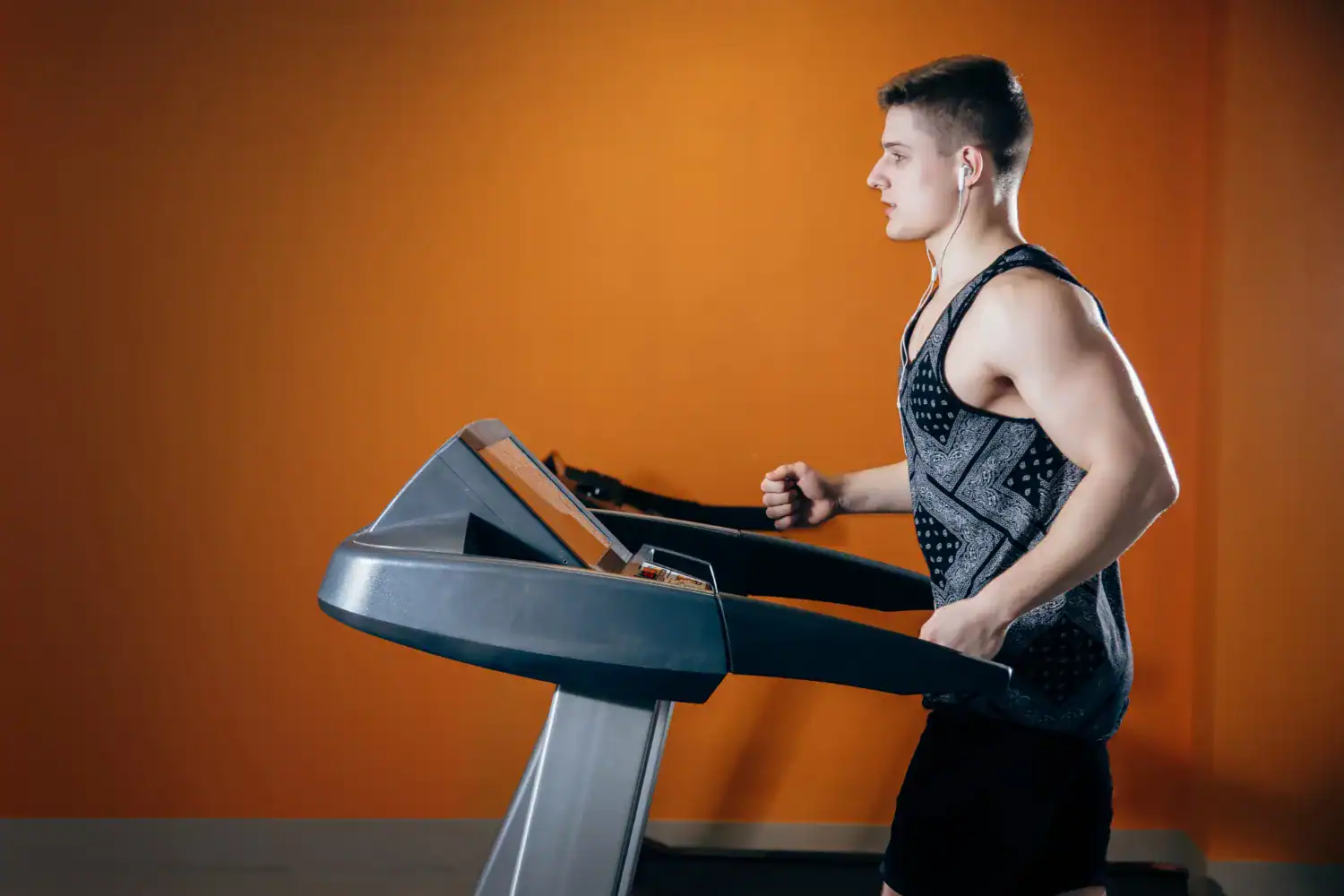 Person exercising on a treadmill to burn belly fat and lose weight