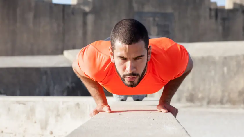 Person performing close grip push-ups to target triceps at home