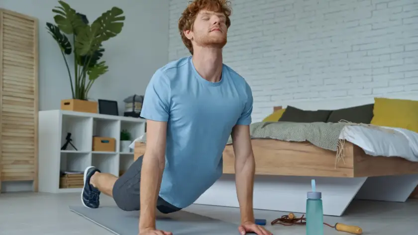 Man doing stretching exercises as part of his morning exercise routine to boost energy and focus.