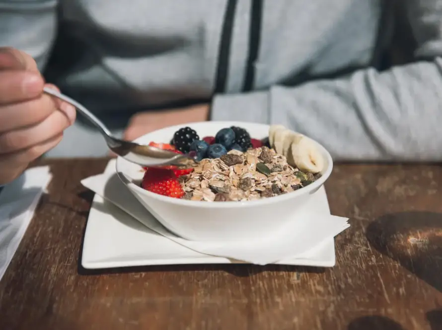 A nutritious high-protein breakfast spread featuring eggs, avocado, Greek yogurt, berries, and whole grain toast on a wooden table, ideal for weight loss.