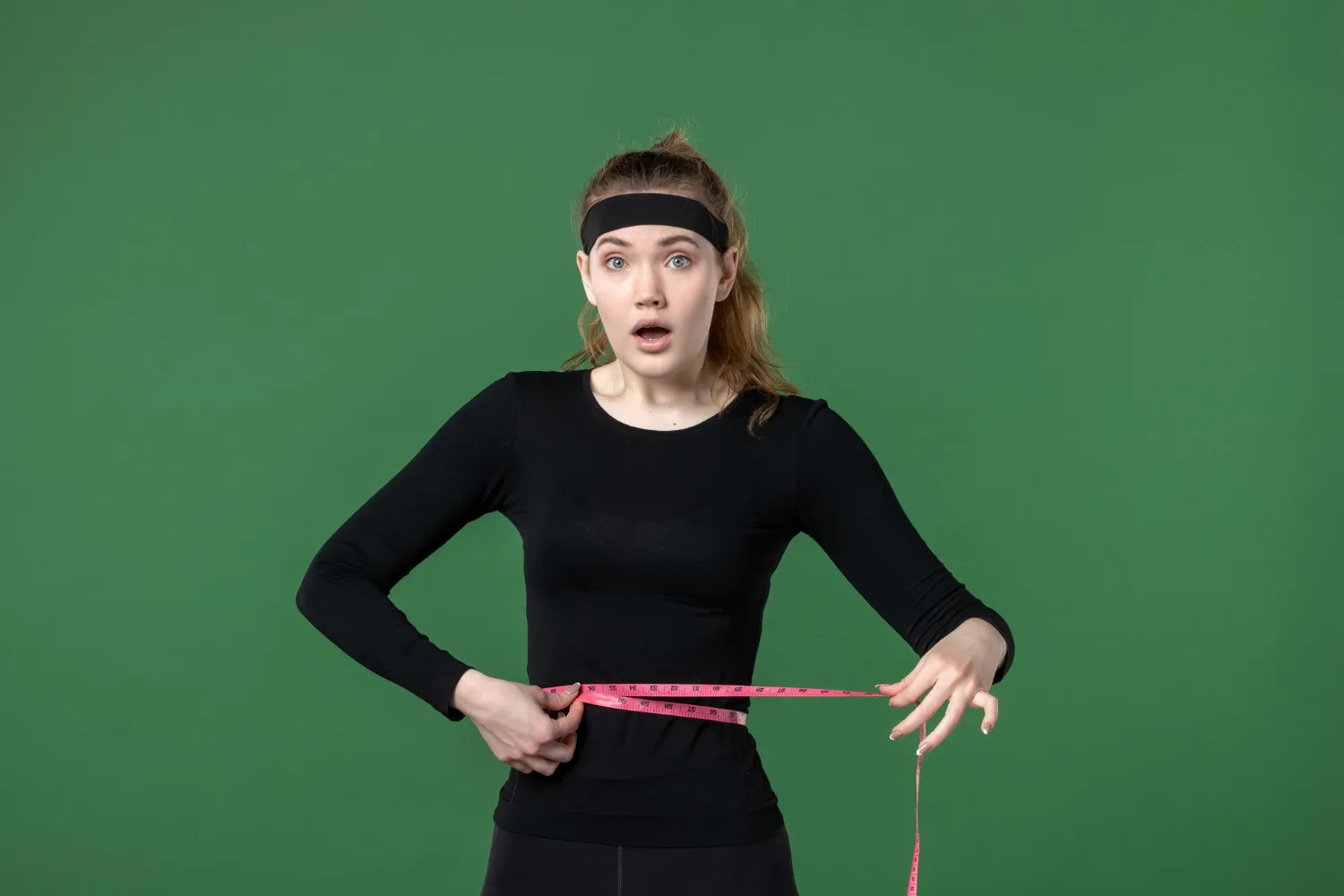 A person working out outdoors with a positive expression, symbolizing weight loss and a healthy lifestyle.