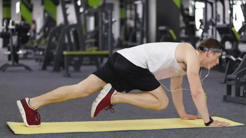 Man performing mountain climber exercise as part of bodyweight workout