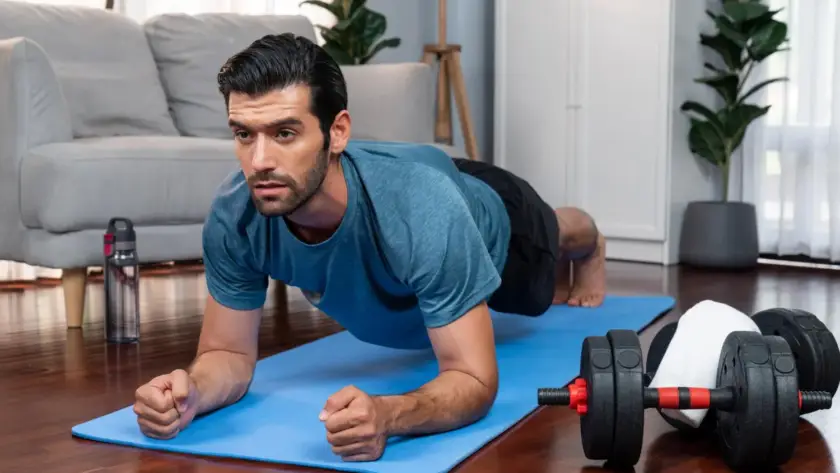 Man doing plank exercise during HIIT workout for weight loss.