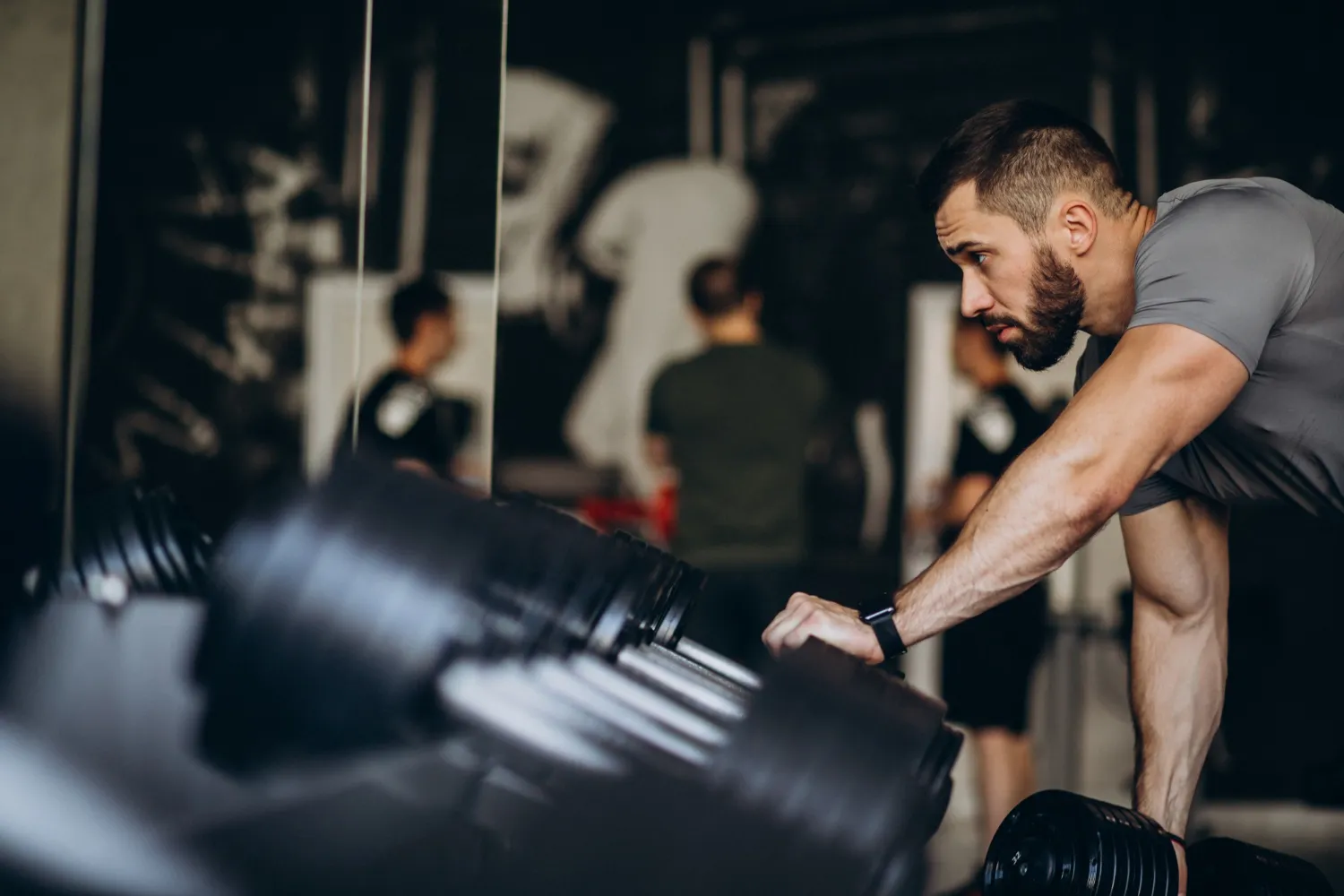 Person lifting weights in a gym to demonstrate how strength training improves longevity and overall health.